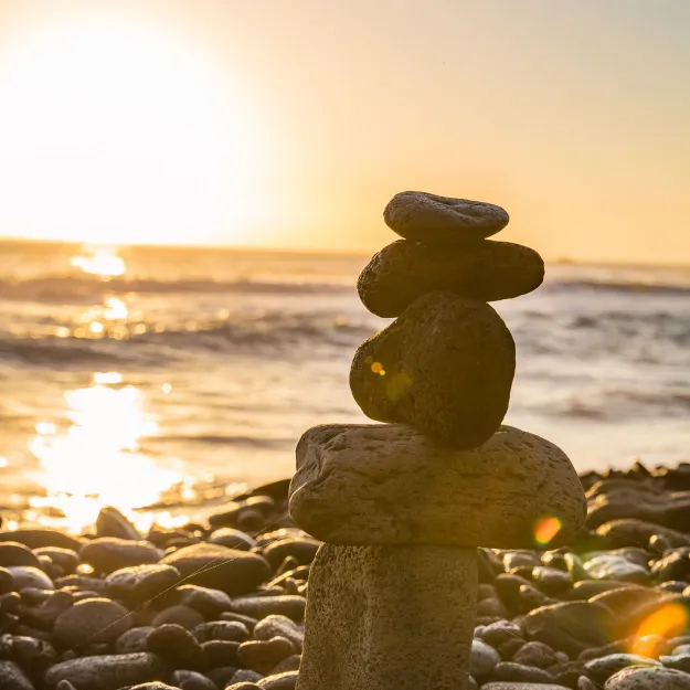 Stacked balancing stones at The Bright Stars Greenroom retreat, symbolizing mindfulness and creative balance