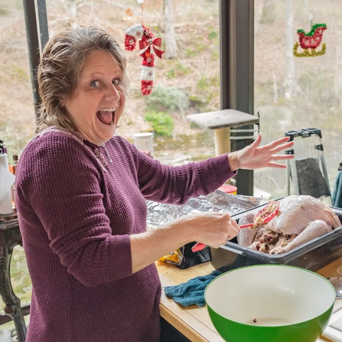 Pamela, a retreat attendee, smiling bright while cooking a delicious meal to celebrate.