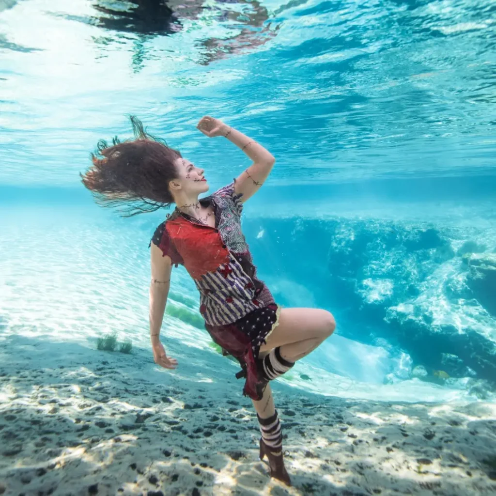 Shannon Scott submerged underwater dressed as Sally from The Nightmare Before Christmas, embodying a magical and spooky mermaid vibe for the Halloween Mermaid Retreat.