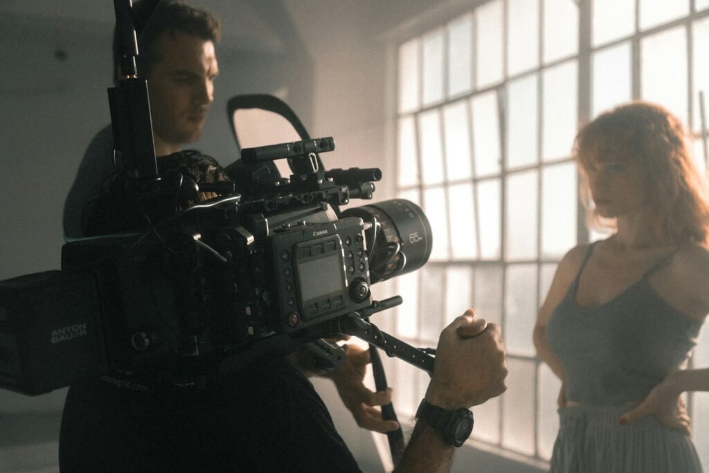 Actor in a dramatic, moody setting being filmed, representing the focused and resilient actor mindset.