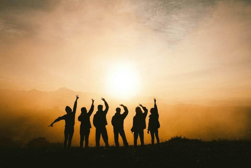 Six people joyfully celebrating together, representing meaningful connection and authentic networking.