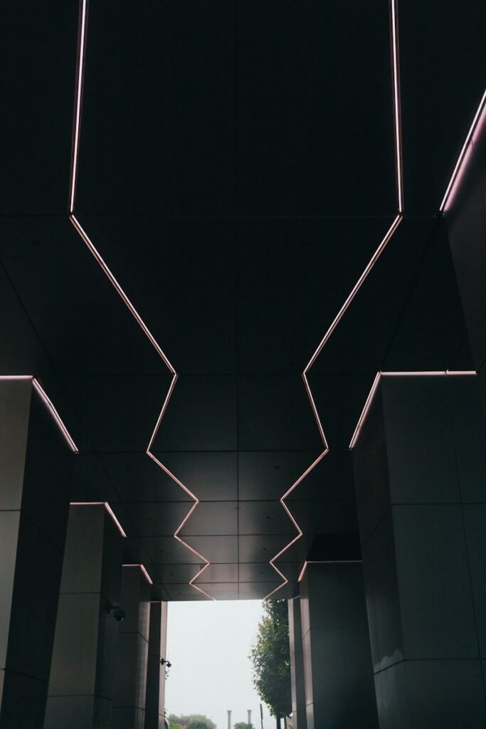 Zigzag neon ceiling lights symbolizing the spontaneous and unpredictable nature of improvisation techniques.
