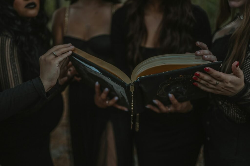 A group of women dressed as witches gathering in a circle during a Halloween retreat for connection and ritual