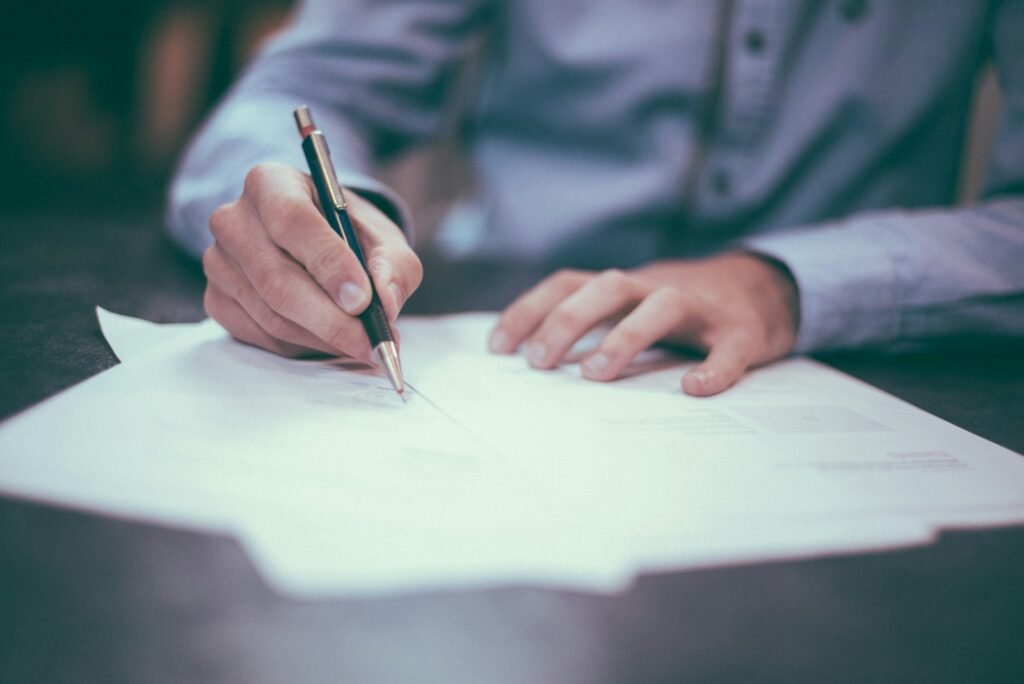 Freelance model reviewing and signing a contract as part of modeling safety practices.