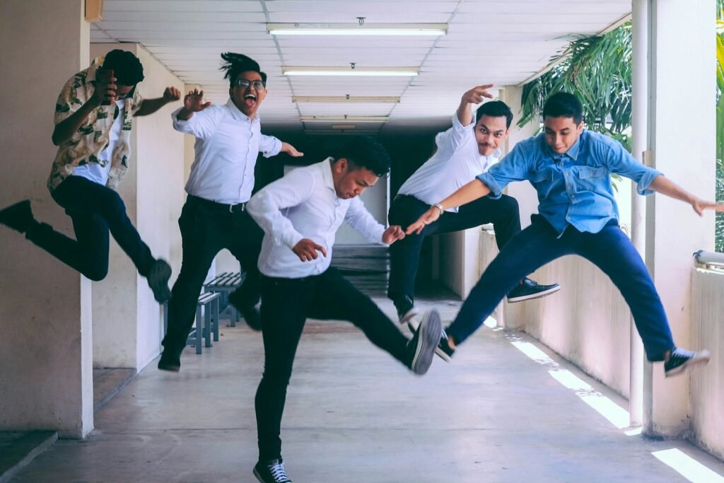 A group of friends mid-air as they jump together, laughing and carefree—capturing the joy and spontaneity of human connection.