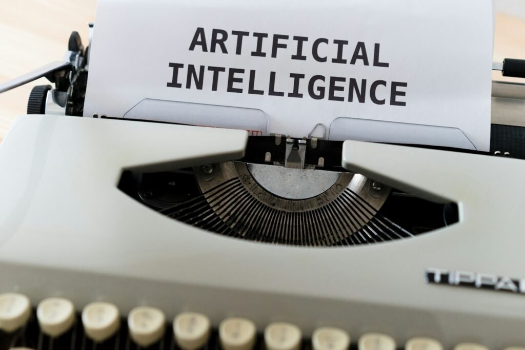 A vintage typewriter with a sheet of paper emerging, the words “artificial intelligence” typed on it, symbolizing the intersection of AI and creativity.