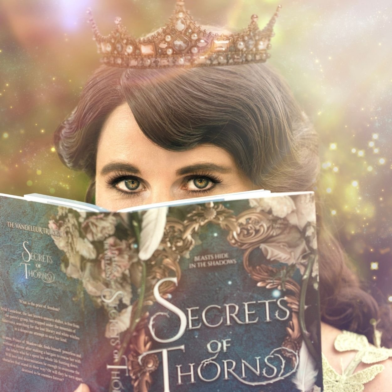 Woman wearing a jeweled crown peeking over the top of a fantasy book